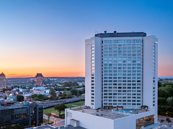 Hilton Québec avec vue du Château Frontenac et du fleuve en arrière-plan.